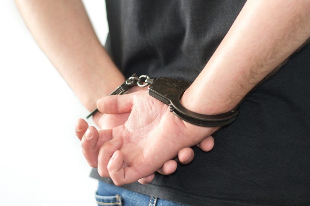 hands in handcuff behind back