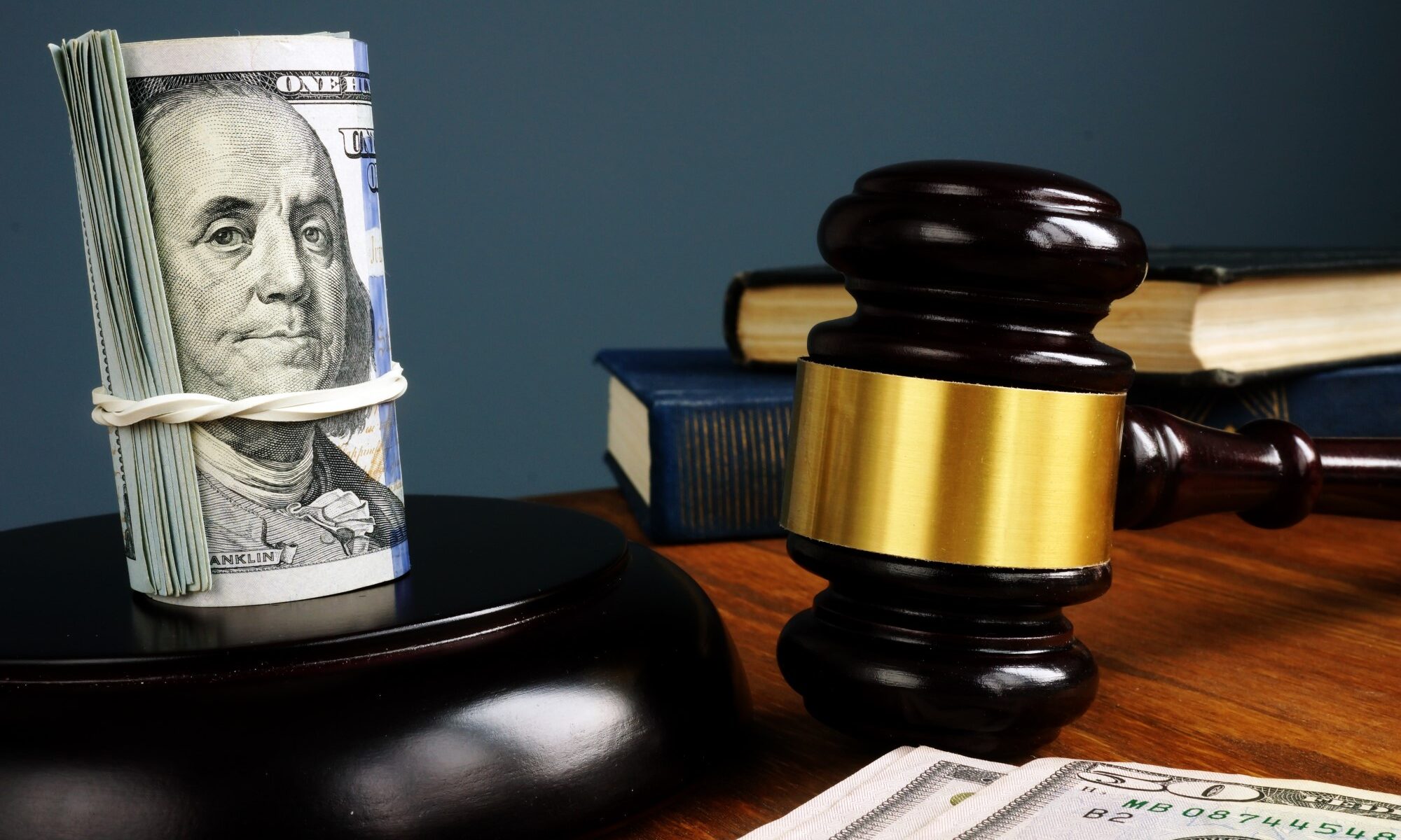 A wad of cash, books, and gavel as collateral for a bail bond